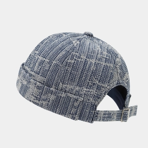 Detail of blue tweed denim miki hat showing weave texture and adjustable metal buckle strap