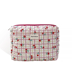 Quilted floral makeup bag with pink zipper and chic star and moon fabric label