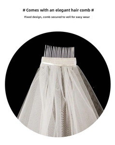 Detailed view of white tulle bridal veil with integrated hair comb for easy attachment
