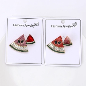 Detail of cute watermelon stud earrings with pink and green rhinestones on display cards