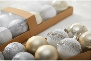 Macro shot of 6cm silver and white Christmas balls with glitter patterns in a craft box