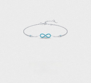Macro shot of S925 silver infinity bracelet featuring turquoise micro-pave stones