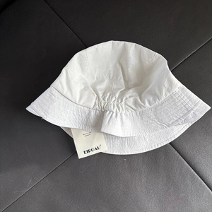 White breathable quick-dry sun hat for women with asymmetric brim and brand tag