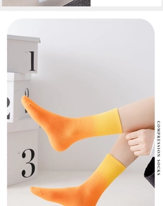Close-up of orange gradient compression socks showing premium knitted texture