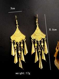 Detail shot of golden ethnic earrings with bells and tassels including size specifications