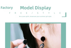 Detail of black acrylic flamingo skeleton earrings on a model for Halloween style
