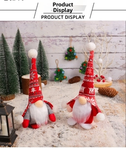 Detail of plush Christmas gnomes with knitted snowflake hats in red and gray colors