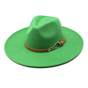Detailed close-up of wide brim green wool fedora with brown leather band and gold buckle