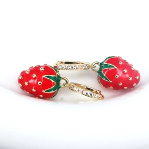 Detailed macro view of red enamel strawberry earrings with sparkling CZ crystal inlay