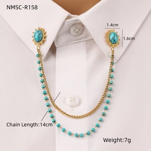 Detail of shirt collar pin with oval turquoise stones and golden chain on white shirt