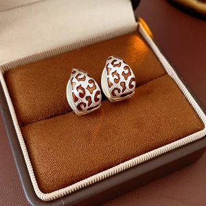 Detail showing retro leopard print hoop earrings in a premium velvet jewelry box