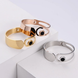 Minimalist stainless steel open bangles in gold, silver, and rose gold with black accents