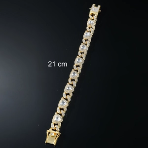 Detail of 21cm gold cuban link bracelet with white zircon hearts and pavé clasp