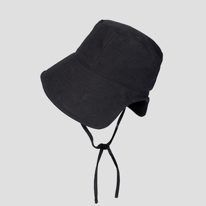 Close-up of black sun hat with wide brim, ear flaps and adjustable chin drawstring