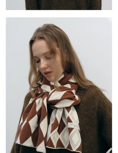 Detailed view of brown and white diamond knit texture on a high-quality winter scarf