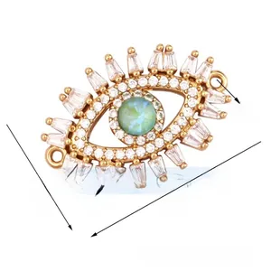 Detailed macro view of gold evil eye jewelry connector with white zircons and opal stone