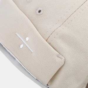 Minimalist beige canvas docker hat with chic division symbol embroidery detail