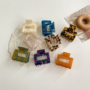 Set of eight square acetate hair claws with tortoiseshell and marble patterns on lace
