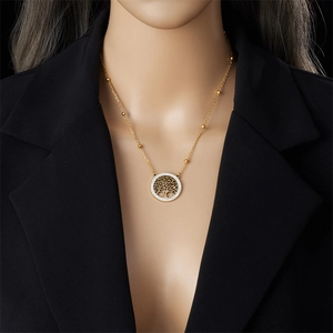 Gold tree of life necklace set with sparkling gems on model in professional studio setting