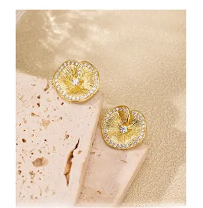 Detail of S925 silver lotus leaf stud earrings with brushed texture and zircon stones