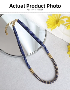 Detailed shot of lapis lazuli beads and golden metal spacers on a handmade necklace