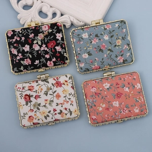 Floral print pocket mirrors with golden metal frames in four assorted pastel colors
