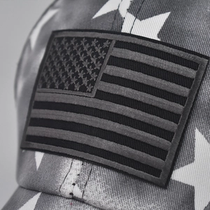 Macro shot of embroidered US flag patch and star pattern on cotton baseball cap