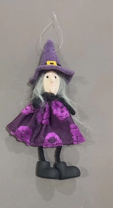 Detail of Halloween witch doll hanging decoration with purple hat and skull print dress