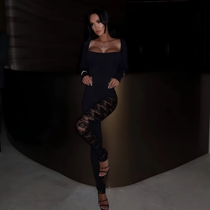 Close-up of sexy black lace patchwork jumpsuit with low-cut square neck and floral mesh