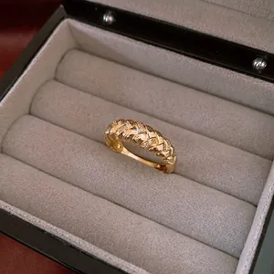 Vintage gold twisted ring with zircon inlay presented in a luxury velvet jewelry box