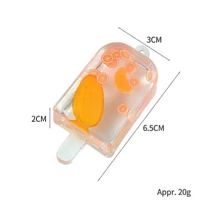 Realistic orange and mango popsicle keychain made of resin with fruit slices