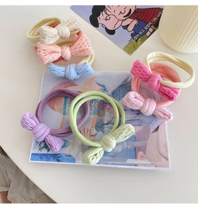 Detail of colorful corduroy bow hair ties in soft pastel tones for women and girls