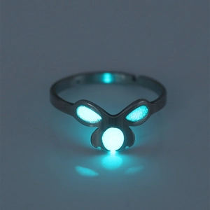 Macro detail of adjustable luminous ring glowing bright blue in the dark night