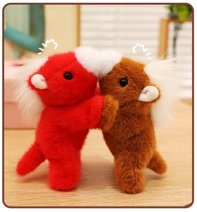Close-up of red and brown plush horse magnets with fluffy white manes on a desk