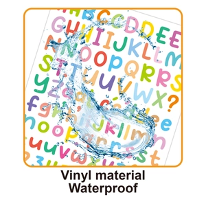Macro shot of waterproof colorful vinyl letter stickers with water splashes on surface