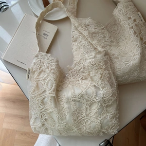 Elegant off-white lace tote bag featuring floral embroidery and retro aesthetic