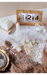 Detailed view of clear acrylic Christmas ornaments including bells and snowflakes