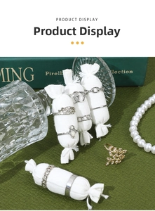 Bohemian style ring collection with pearl necklace on a linen jewelry display stand