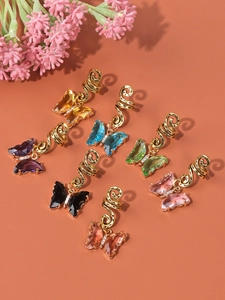 Close-up of gold hair rings with colorful crystal butterfly charms in a seven-piece set