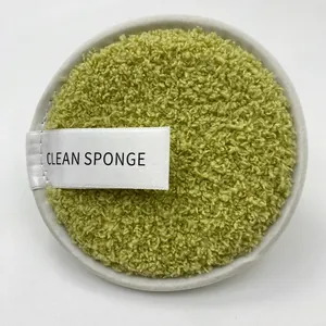 Macro detail of round green microfiber cleansing puff with printed clean sponge strap