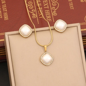 Elegant gold pearl jewelry set featuring square pendant necklace and stud earrings