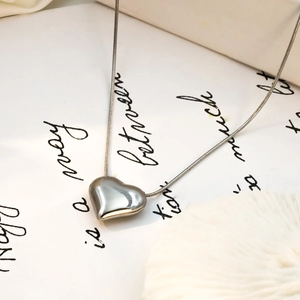 Minimalist 18k gold heart pendant necklace with sleek snake chain and metallic silver finish