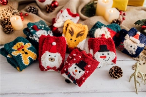 Detail of soft coral fleece Christmas socks with festive cartoon 3D embroidery patterns