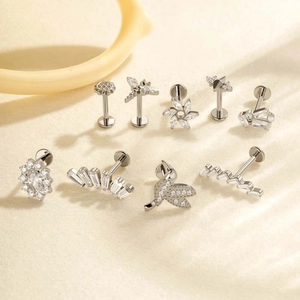 Collection of silver G23 titanium labret studs with flower and bird designs