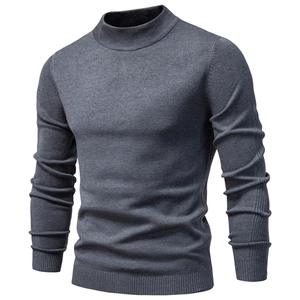 Detail of dark grey mock neck sweater showing ribbed cuffs and premium knit texture
