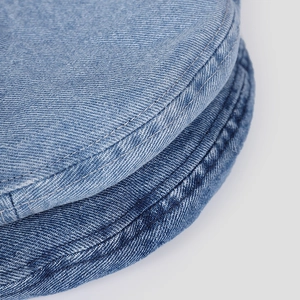 Detailed close-up of retro washed denim beret featuring reinforced double-stitch seams