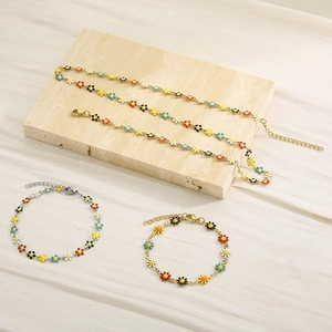 Detailed shot of titanium steel bracelets with colorful painted daisy floral charms