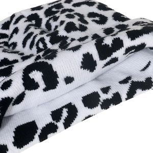 Close-up detail of knitted fabric showing zebra print pattern in black and white