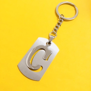 Polished silver stainless steel keychain featuring a hollow letter C on a vibrant yellow background