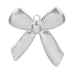 Macro view of silver bow-shaped pendant with striped texture and top loop for DIY jewelry